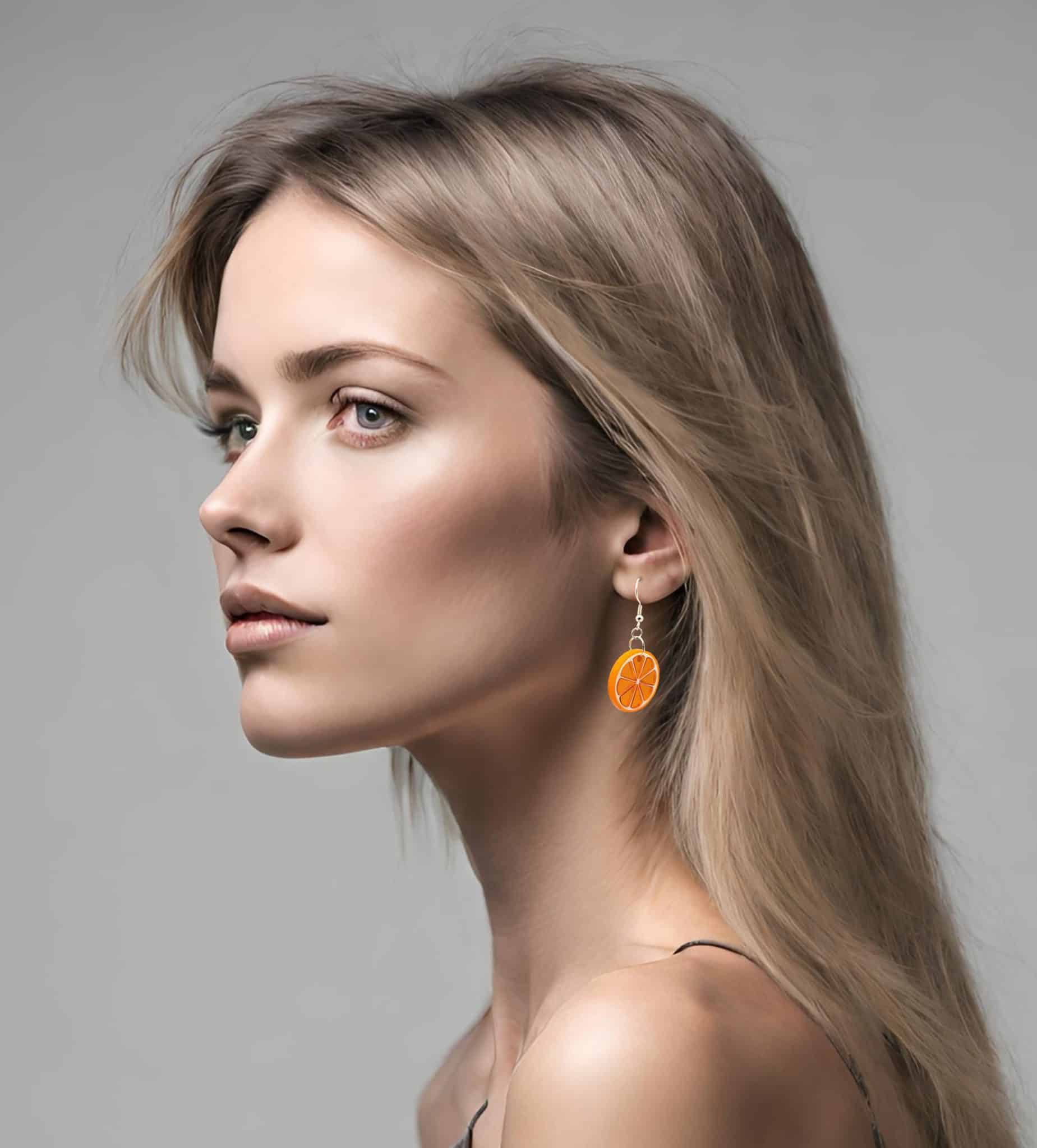Young woman wearing hand made Orange Fruit Earrings by Marquise Jewellery