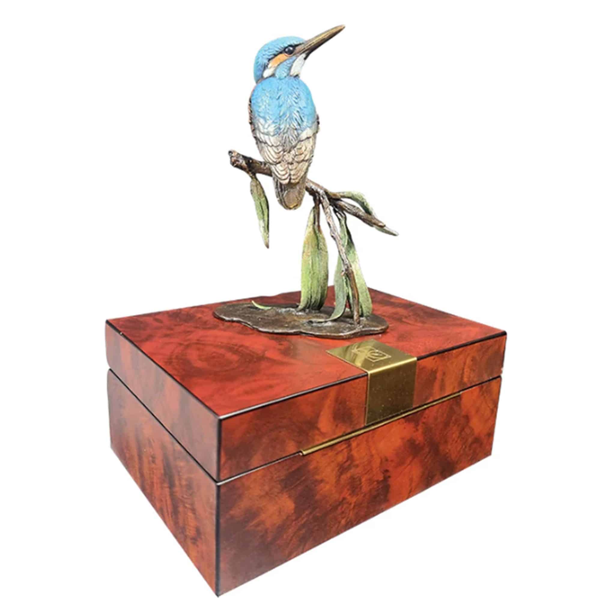 Richard Cooper solid bronze kingfisher with willow sculpture displayed on top of its premium high-gloss wooden presentation box with gold hardware.