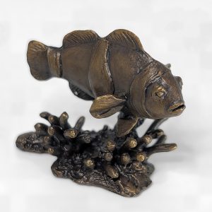 Solid bronze clownfish sculpture swimming over a coral reef base with distinct white band details and rich patina by Marquise Jewellery