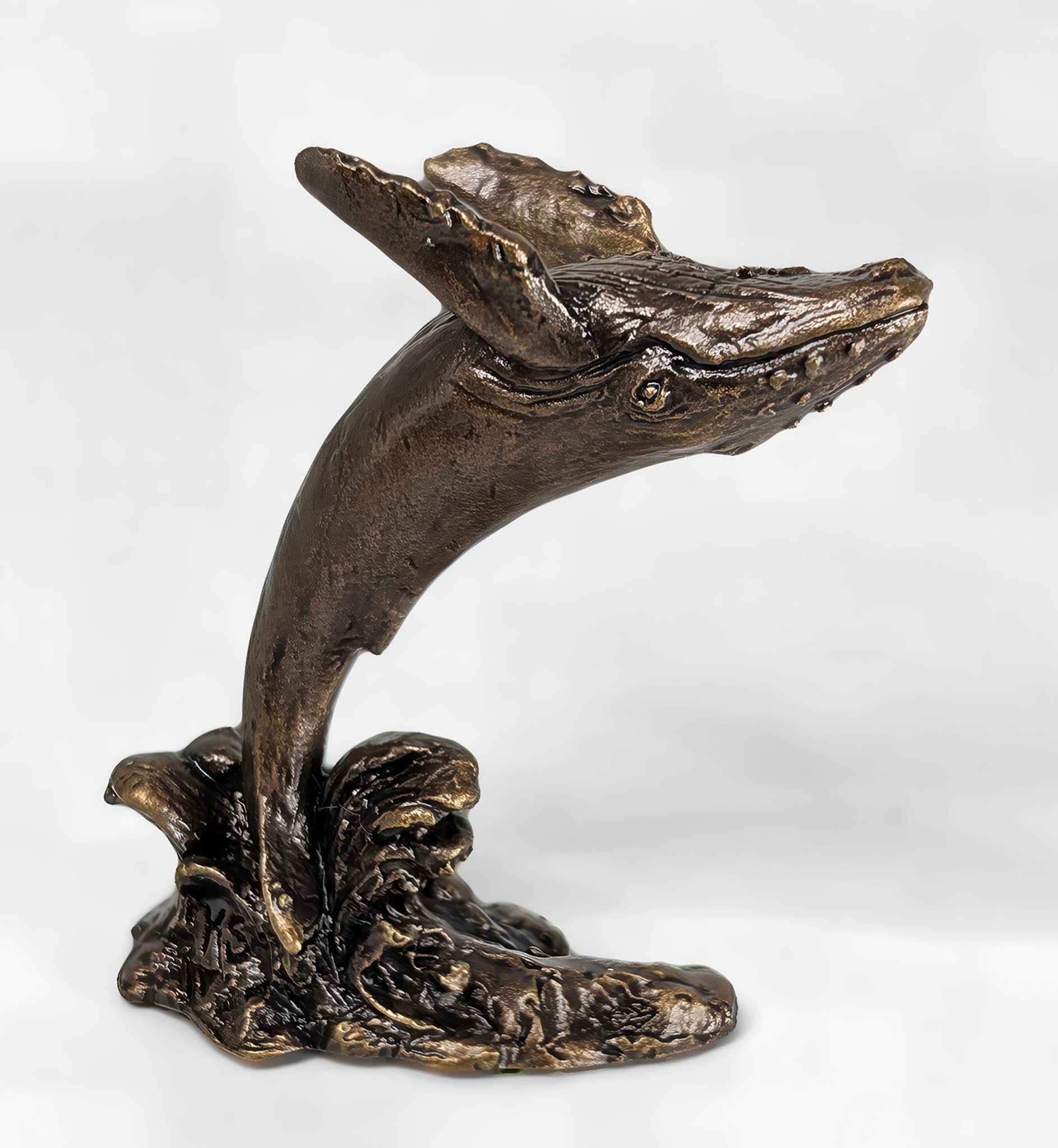 Solid bronze humpback whale sculpture leaping backwards to the right with multi-tonal patina finish by Marquise Jewellery