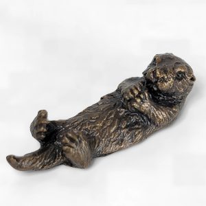 Solid bronze sea otter sculpture resting on its back with paws folded across chest and detailed fur patina by Marquise Jewellery