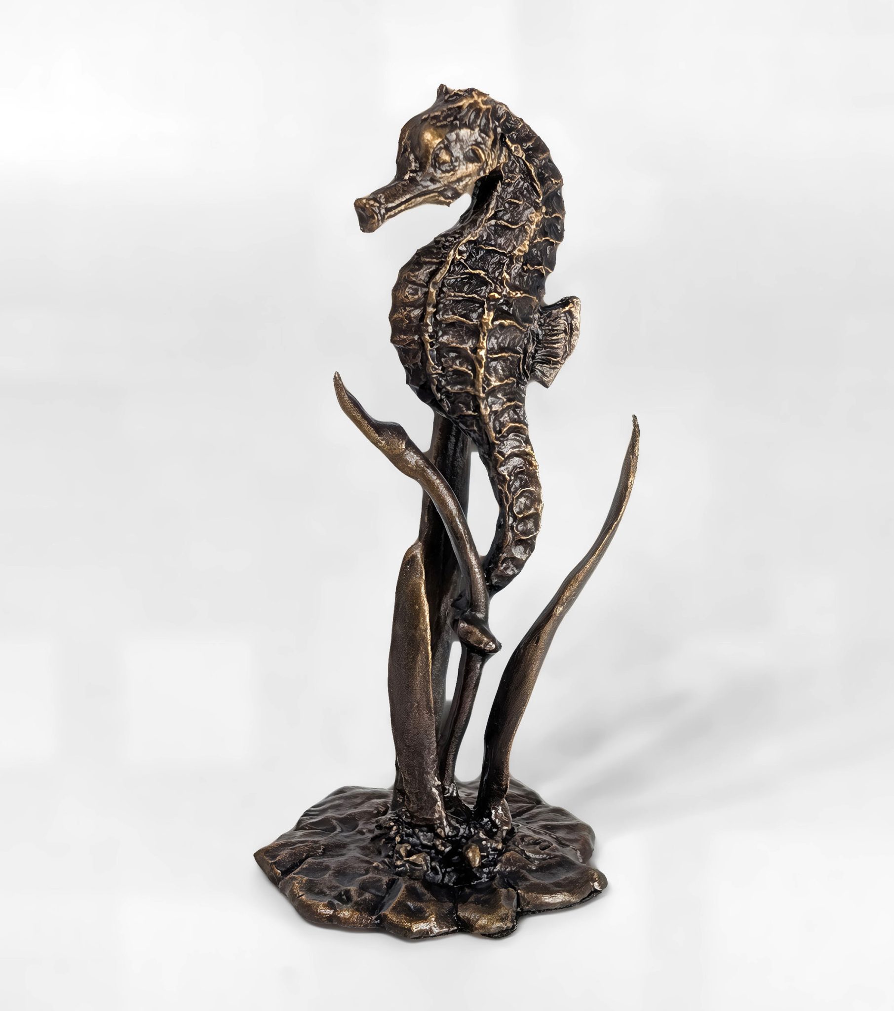 Solid bronze seahorse sculpture anchored among seagrass on a decorative base with multi-tonal patina finish by Marquise Jewellery