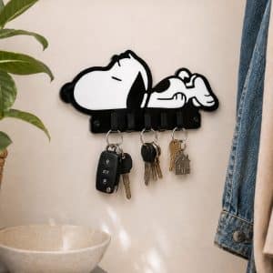 Handmade black and white inlaid acrylic Sleeping Snoopy Dog Keyring Hanger mounted on a hallway wall with sets of keys hanging from 5 integrated hooks